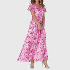 Zoom sur l'imprimé floral corail et pêche de la robe longue