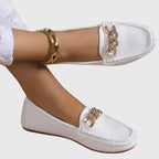 Mocassins blancs femme avec chaîne dorée sur l'empeigne, vue de face