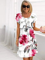 Robe midi fleurie blanc rose vue de face avec volants étagés